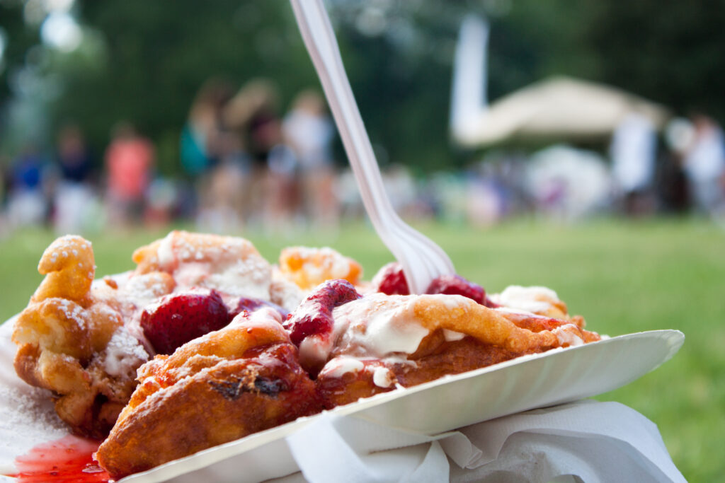 delicious strawberries and gooey icing drips down on the decadent deep fried funnel cakes, a summer fair favorite.