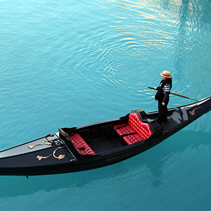 Venetian gondola on blue turquoise waters