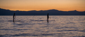 Paddleboarding at sunset on the water