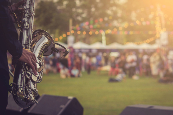 jazz musician playing trumpet on stage in outdoor venue