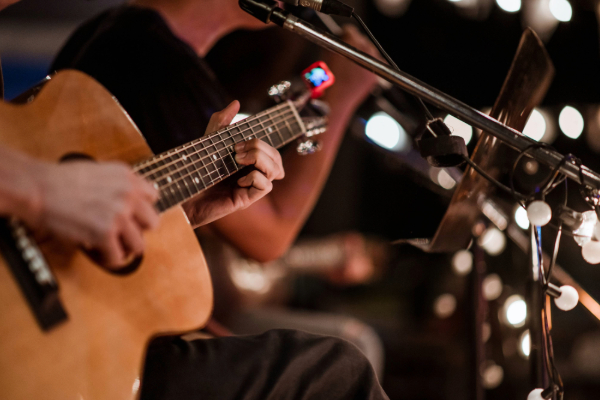 musician playing guitar close up